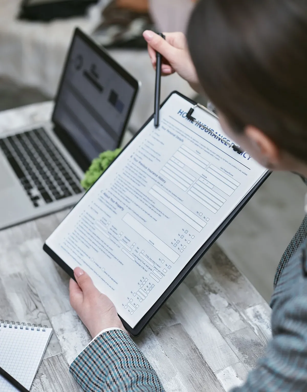 A person reviewing a Guardian dental insurance policy document at a desk