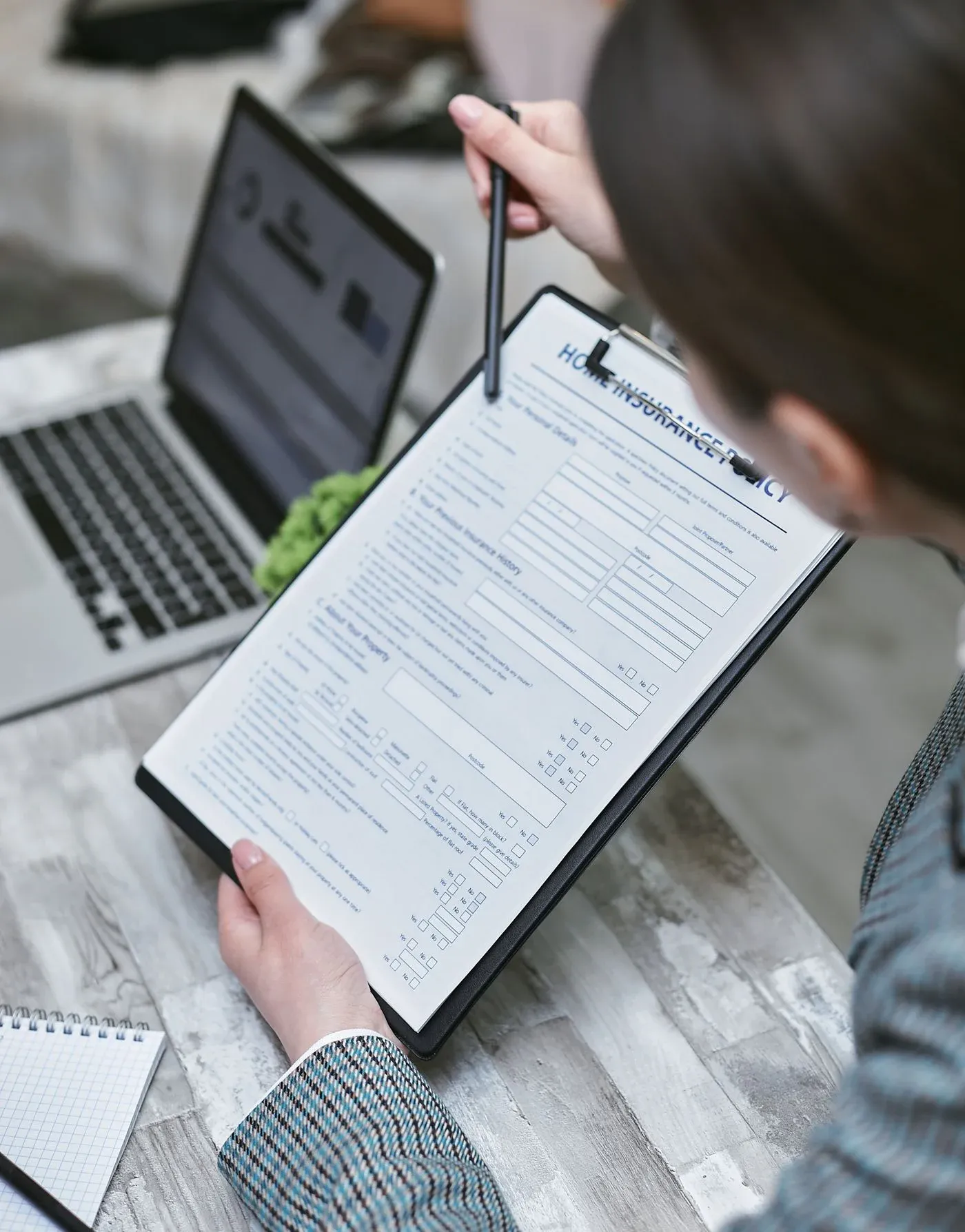 A person reviewing a Guardian dental insurance policy document at a desk