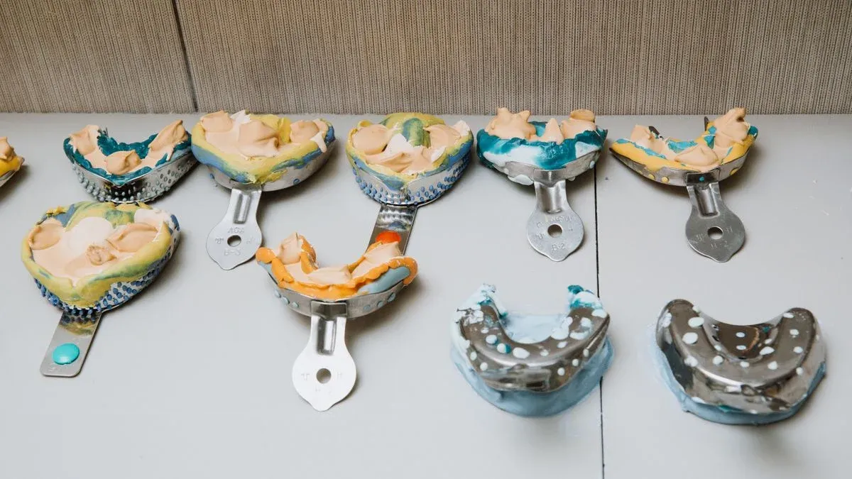 Set of alginate dental impressions on a tray, the step an online lab uses to fabricate a custom night guard