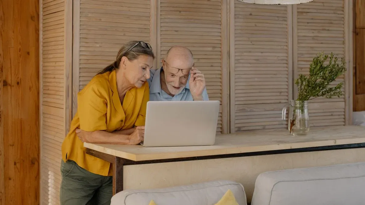 Senior couple looking at a laptop together, researching Medicare Advantage dental coverage options