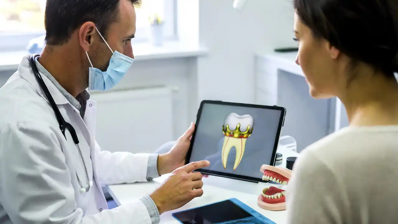 Dentist explaining dental crown treatment and insurance coverage