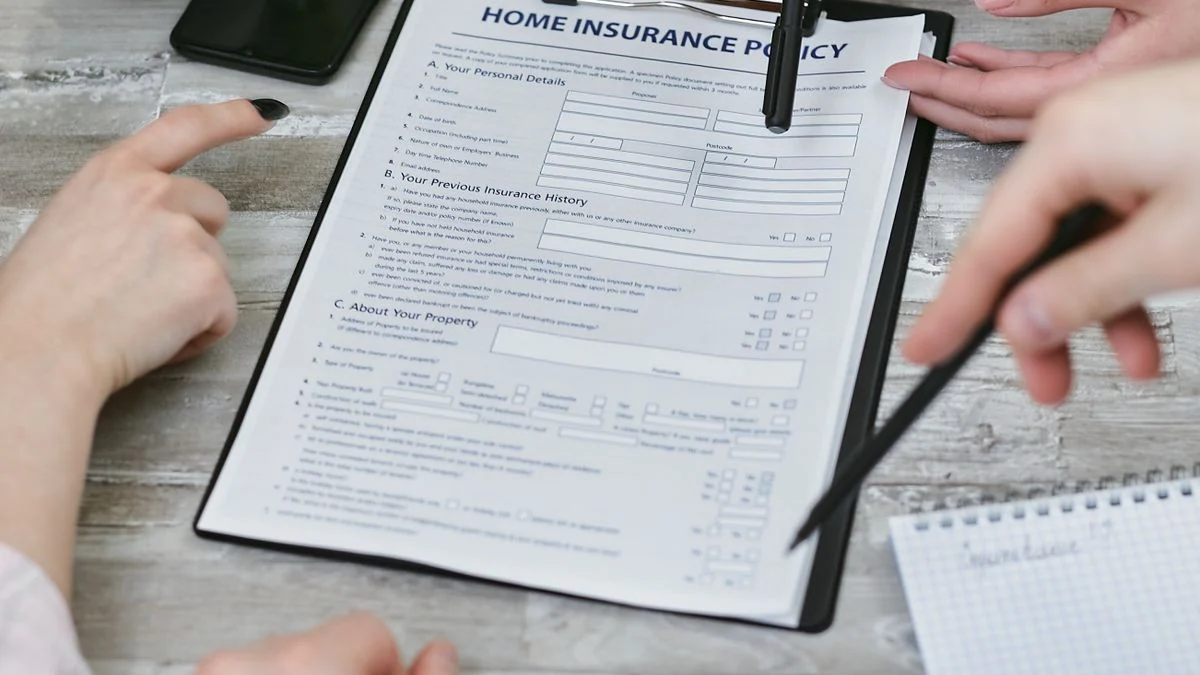 Insurance policy paperwork being reviewed, representing comparing family dental insurance plans before enrolling