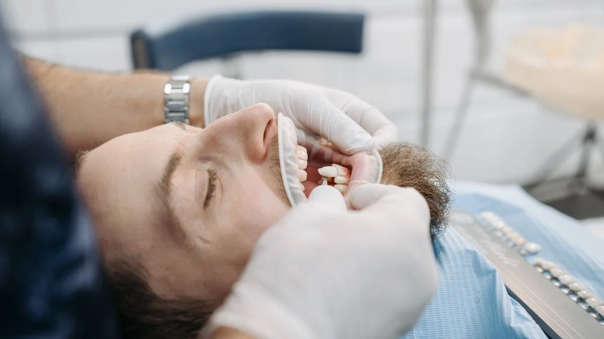 A patient at the dentist's office during treatment, representing major work like a crown or root canal
