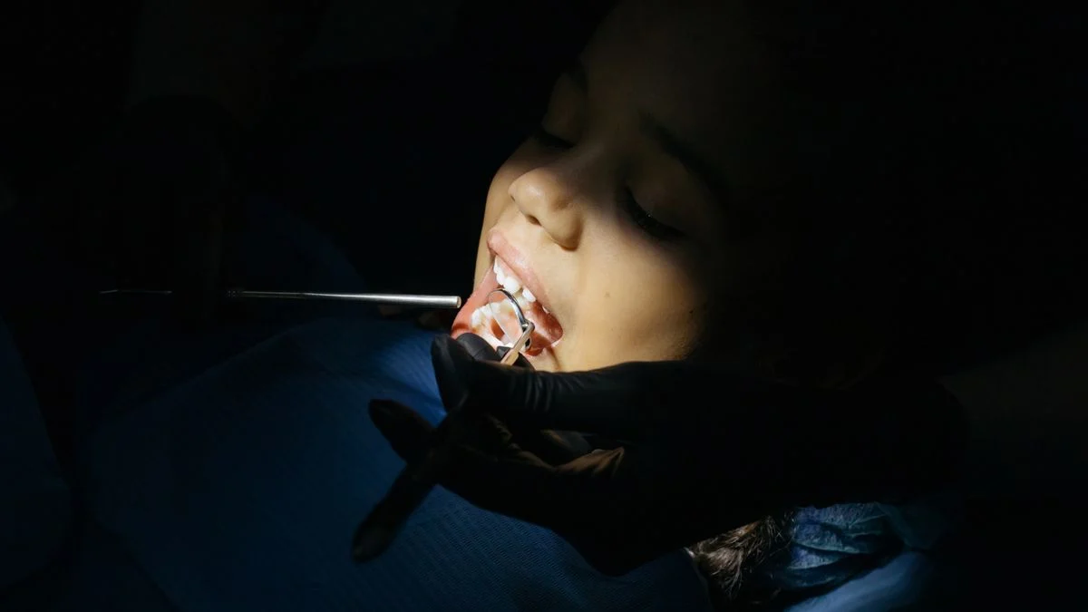 A parent and child at a dental visit, representing the choice between PPO and HMO family dental plans