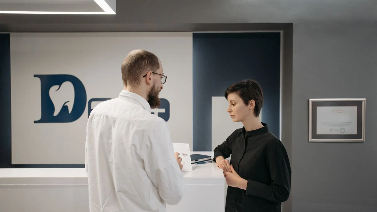 A dentist treating a patient, representing the PPO versus Premier participation tiers on Delta Dental plans