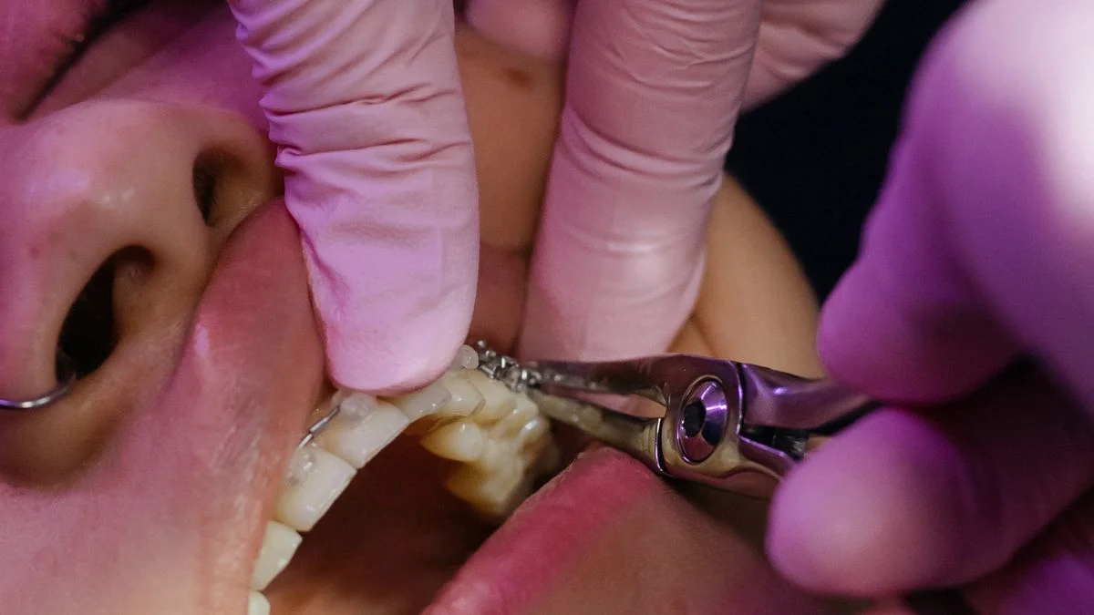 Dentist closely examining a patient's teeth to diagnose a dental condition