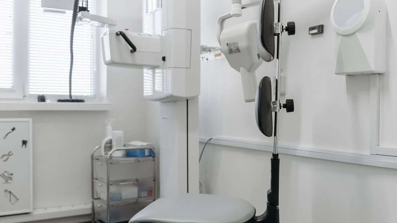 Modern dental office with X-ray equipment and dental chair — both low-premium and high-coverage dental plans cover preventive care at 100%