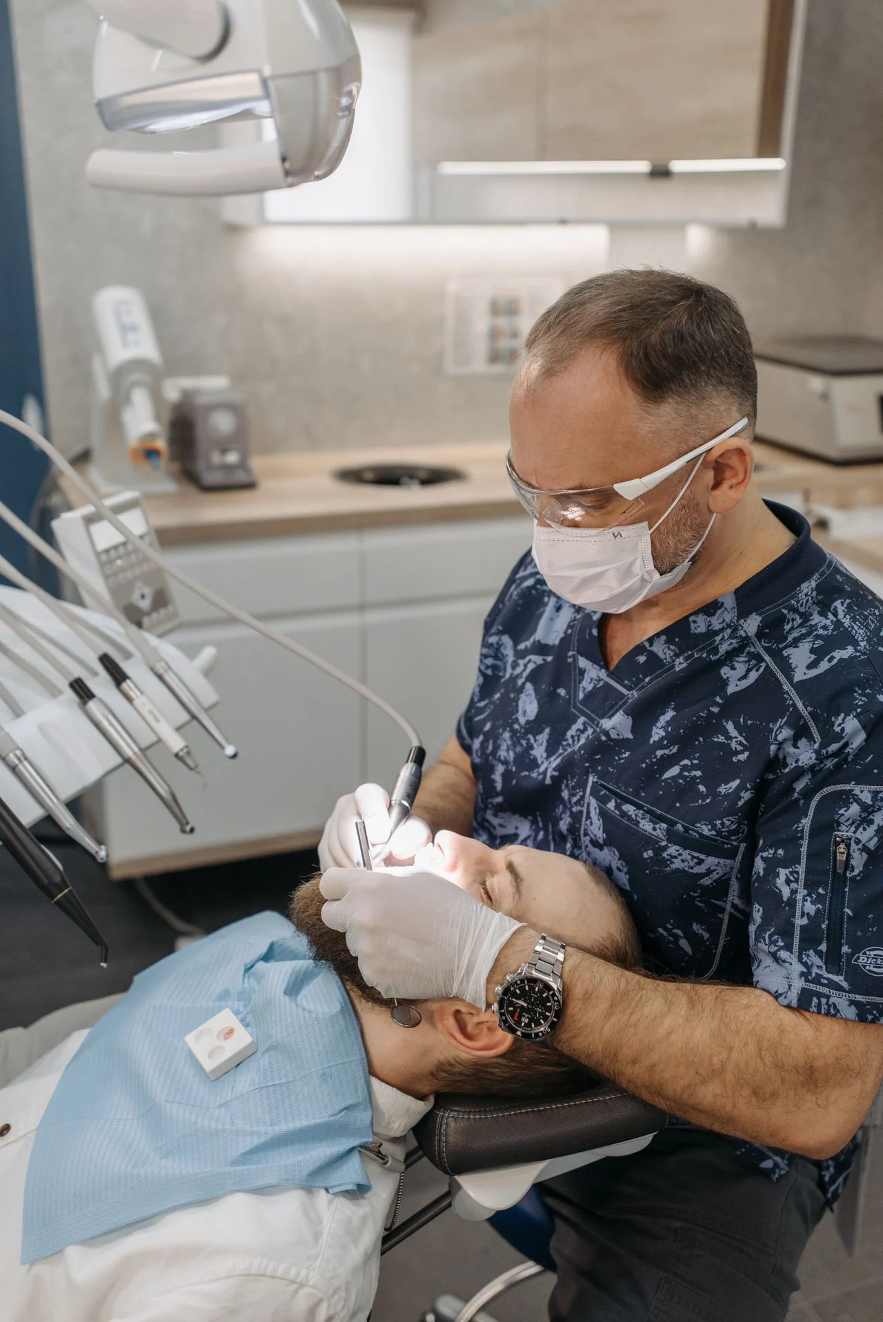 Dentist examining a patient during a routine checkup — the kind of preventive visit most individual dental insurance plans cover at 100%