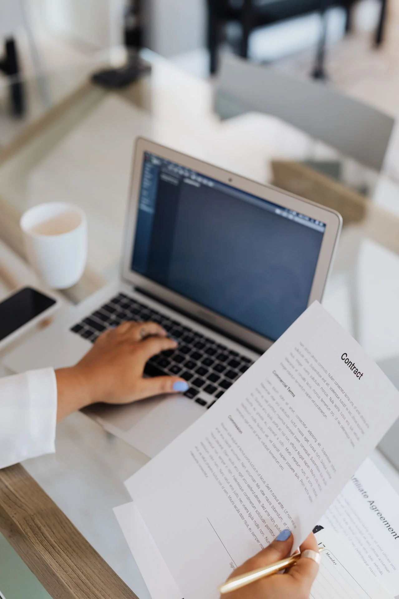 Freelancer reviewing dental insurance documents on a laptop at a home office desk