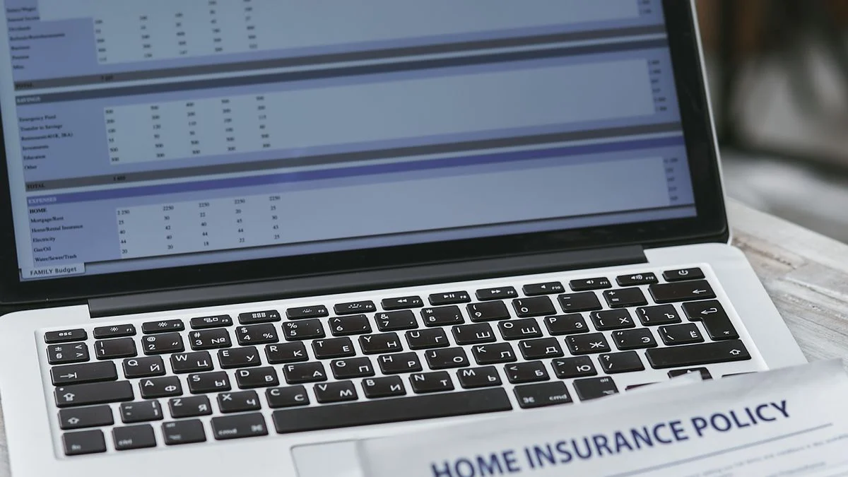 Dental insurance policy documents and a laptop, used to compare Humana plan options