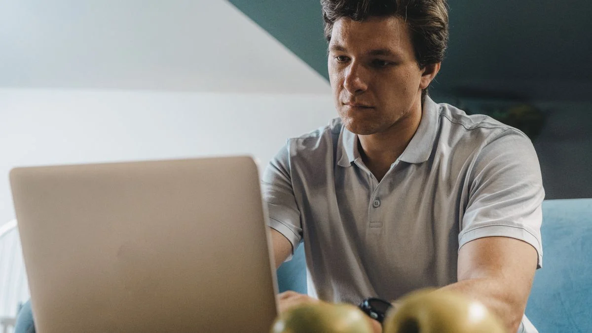 Self-employed freelancer researching Humana dental insurance options Self-employed freelancer comparing Humana dental insurance plans on a laptop