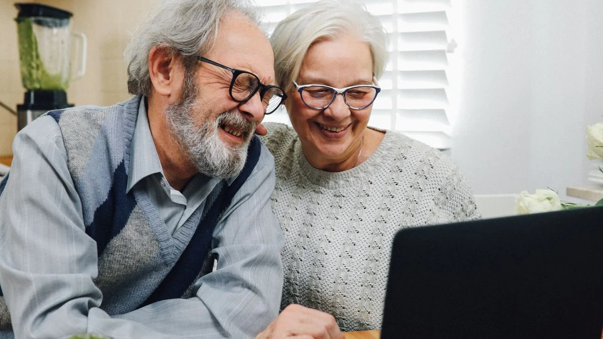 Senior couple reviewing coverage options together at home, relevant to dental insurance planning when a spouse is younger