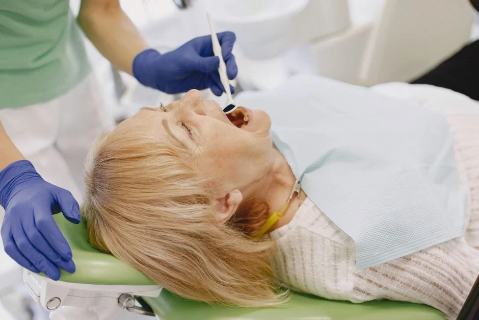 Senior woman receiving dental treatment, relevant to Medicare Advantage dental benefit usage