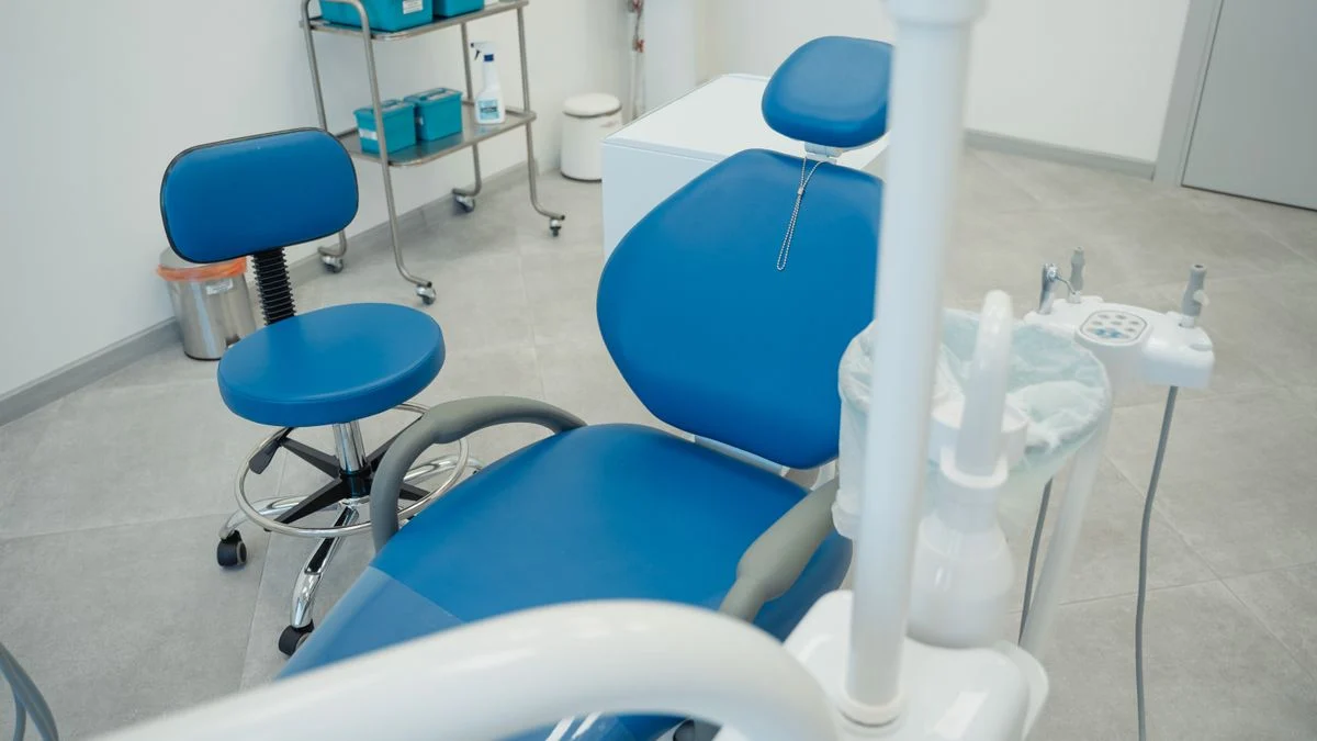Modern dental clinic room with treatment chair, representing a dental office visit Modern dental clinic room with a treatment chair and equipment