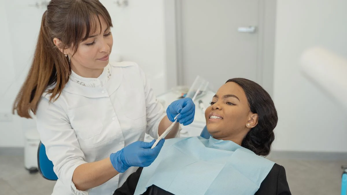 Dentist providing care to a patient during a routine dental checkup in a modern clinic