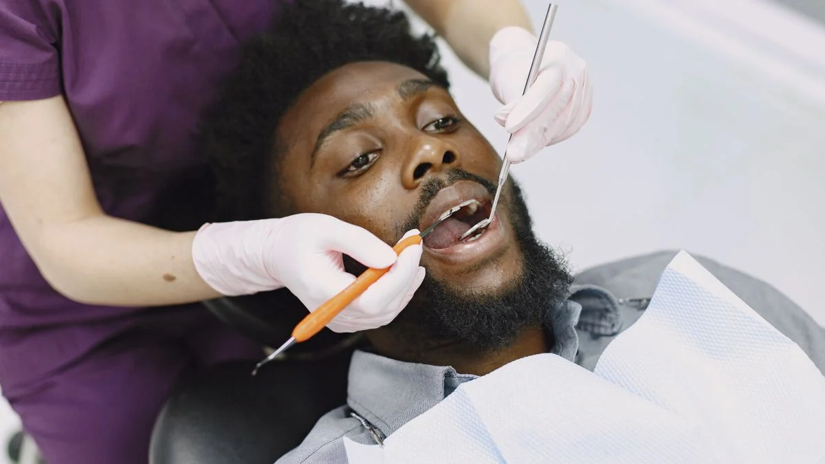 Dentist examining a patient teeth during a routine dental checkup