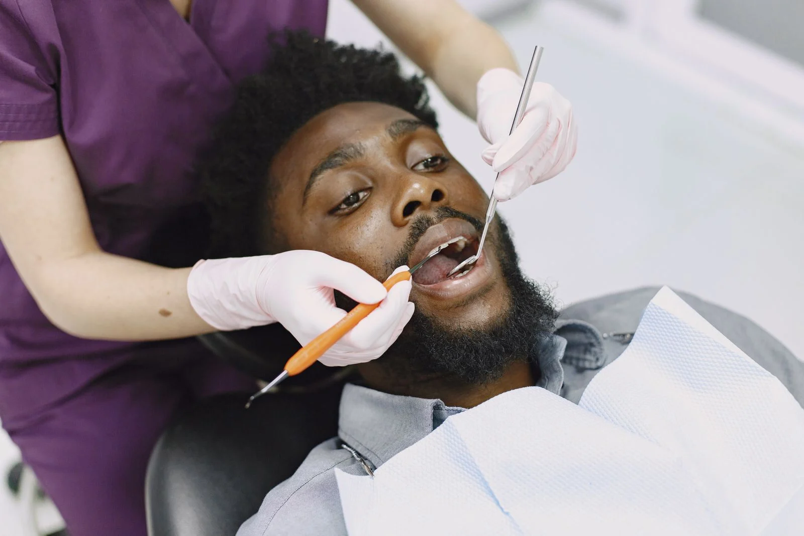 A dentist examining a patient's teeth during a routine dental checkup