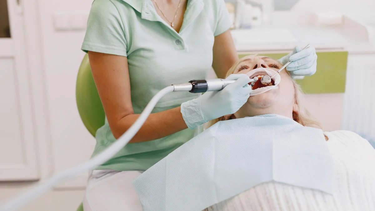 Dentist performing an oral examination on a patient during a routine clinic visit