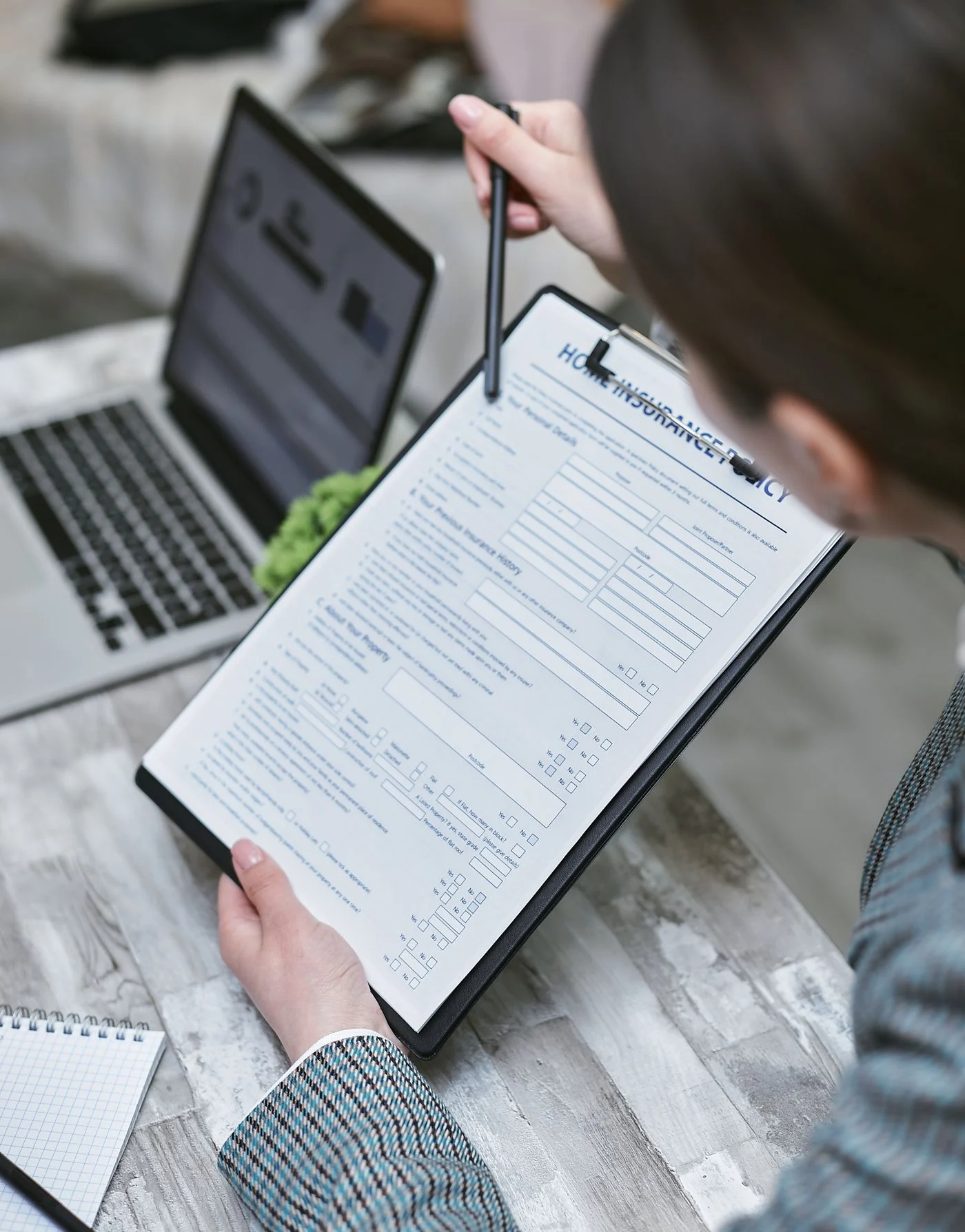 Person reviewing a dental insurance policy document A person reviewing a Guardian dental insurance policy document at a desk