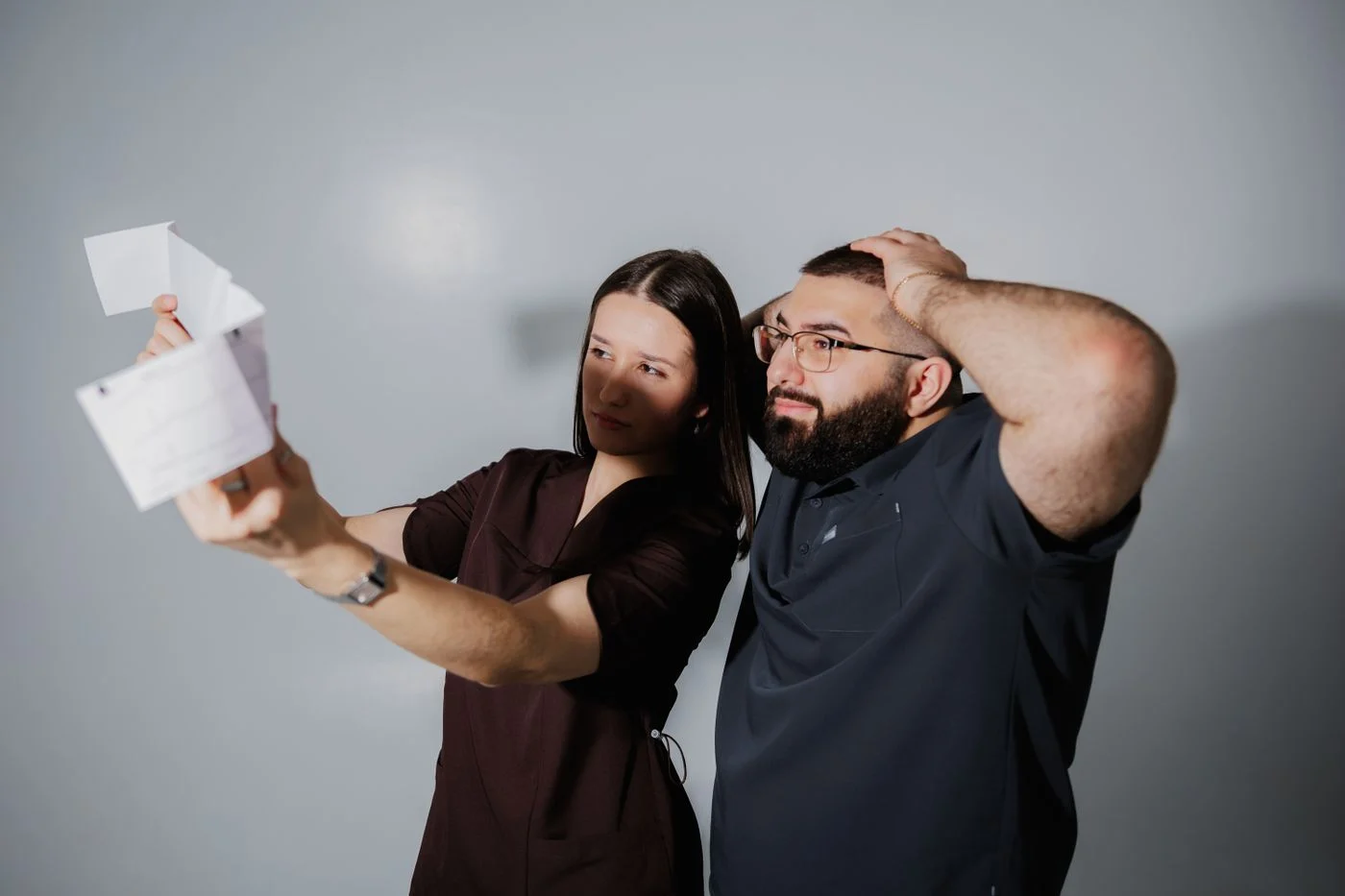Why the night guard bill does not match the estimate A man and woman looking surprised while examining a printed statement together
